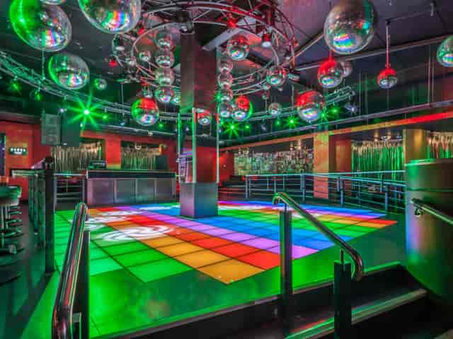 Vibrant Vinyl Club nightlife venue with LED dance floor for corporate galas and social events.