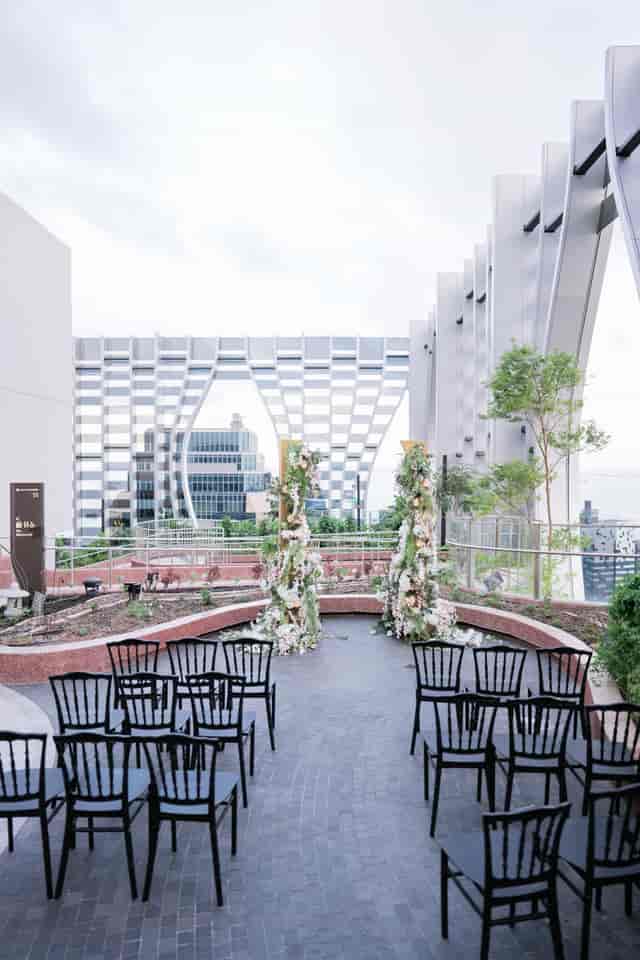 Oumi 1-Arden rooftop with geometric backdrop and florals for luxury wedding or corporate event.
