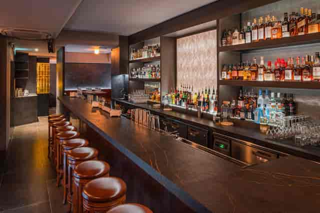 Upscale cocktail bar with moody lighting, ideal for corporate receptions and VIP networking.