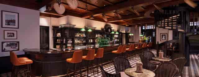 Raffles Room suite with high-top seating for intimate networking receptions and corporate events.