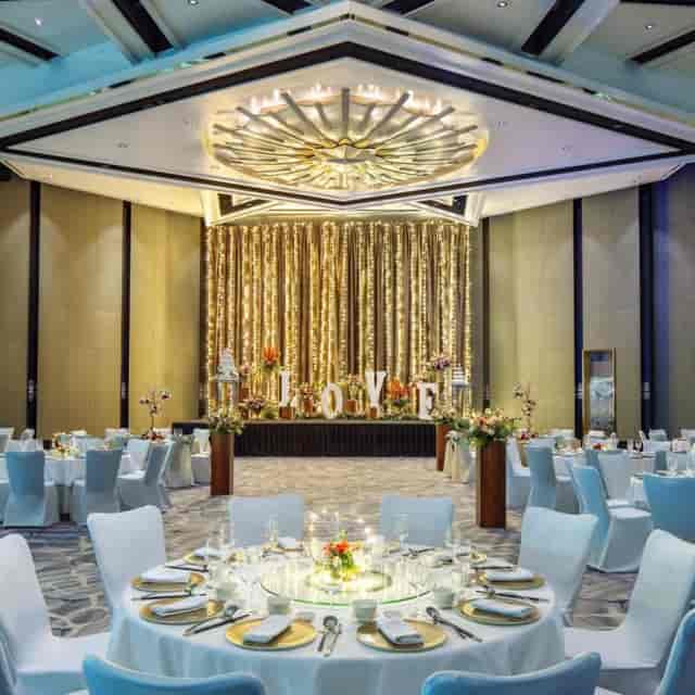 Atrium Ballroom with golden drapery, perfect for elegant weddings and celebrations.