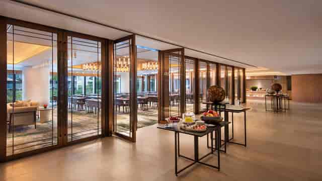 Elegant ballroom in Andaz Singapore for meetings and events, featuring natural light and refreshments.