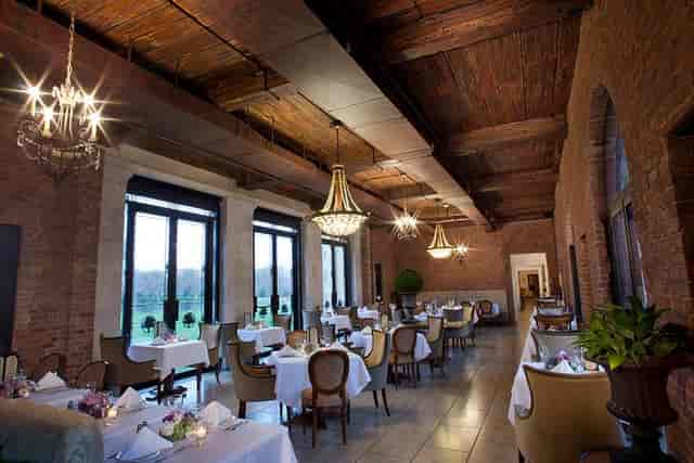 OHEKA Castle function room with exposed brick and chandeliers for corporate dinners or weddings.