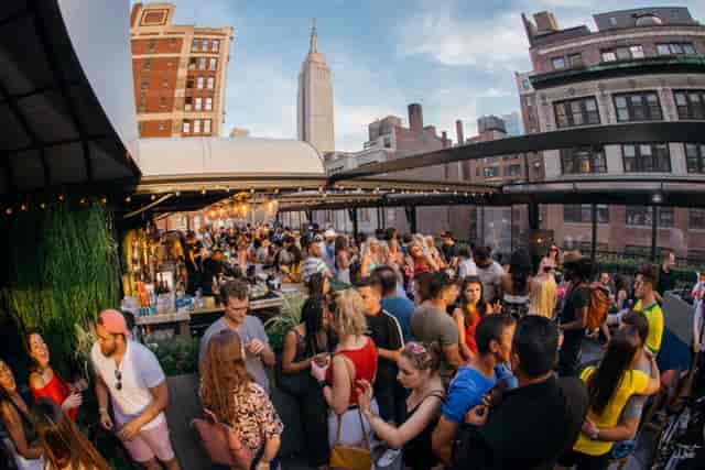 Rooftop reception at Moxy Times Square with Empire State Building views for corporate event planning.