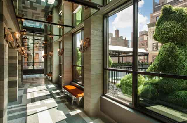 Meeting Studios corridor with natural light for corporate events and networking hubs.