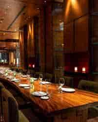 Private dining room at Zuma Dubai with polished wood table for executive dinners and VIP events.