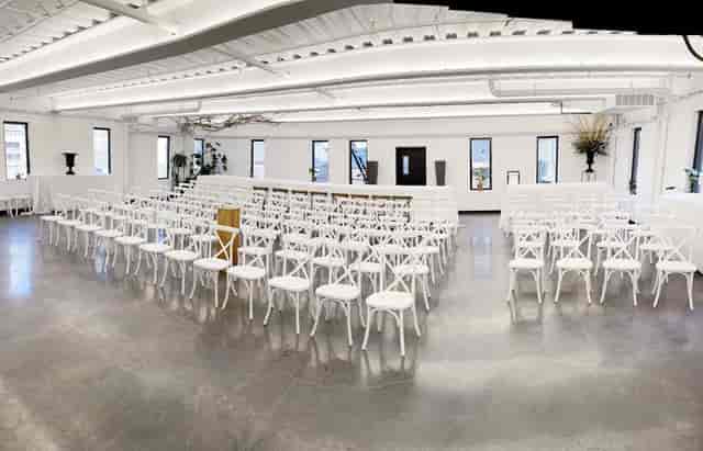 ILA Bar Room industrial-chic ceremony venue with cross-back chairs for luxury wedding events.