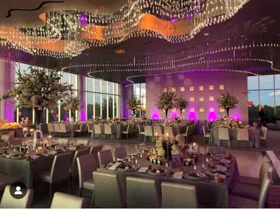 Modern rooftop wedding ballroom with purple LED lighting for galas and elegant events.