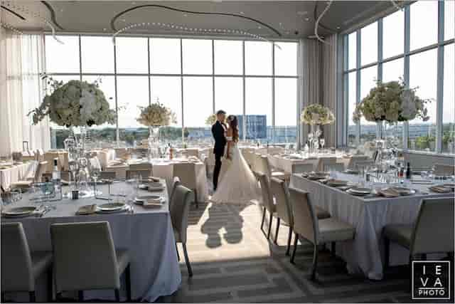High-end rooftop wedding ballroom with floor-to-ceiling windows, perfect for luxury event venues.