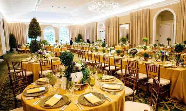 Luxury Garden Terrace Room ballroom with gold tables for weddings and corporate galas.