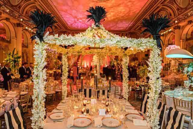 Gala event setup in NYBG Garden Terrace Room with ornate floral centerpieces and luxury lighting.