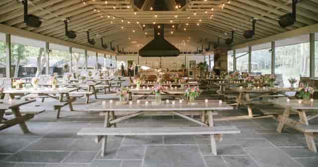 Rustic-chic reception at The Pavilion, Cedar Lakes Estate with bistro lighting for event planning.