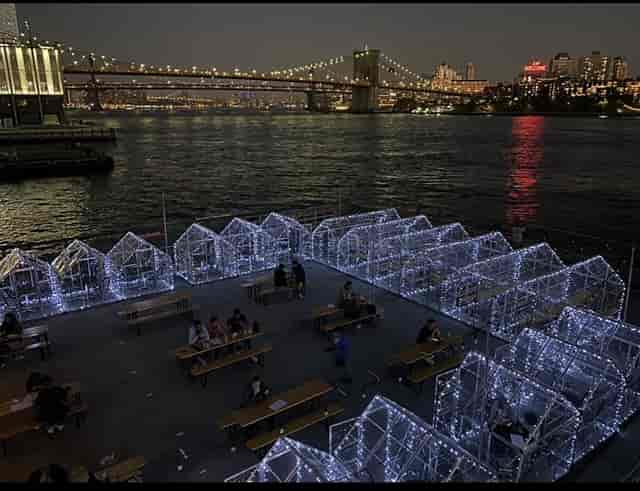 Waterfront pop-up dining pods at Watermark with Brooklyn Bridge views for corporate events.