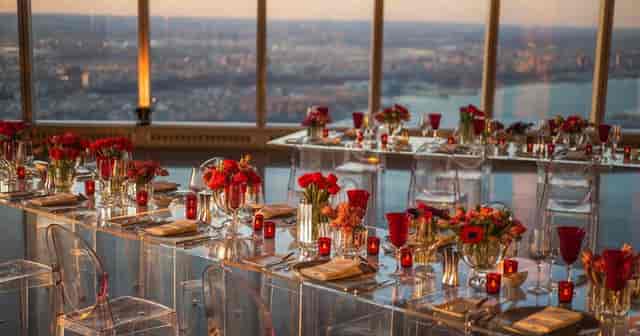 Sunset event space at One World Observatory with modern decor and red floral accents for gala.