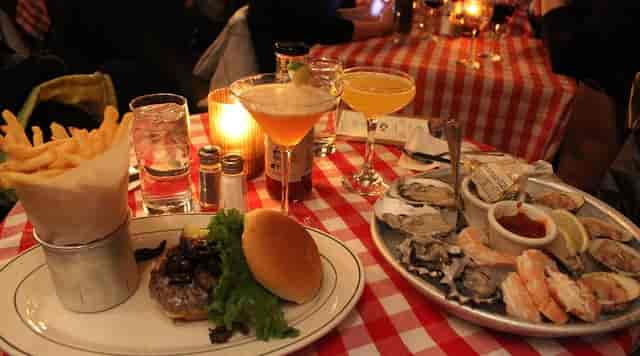 PJ Clarke’s bistro interior with seafood platter for VIP networking or corporate conference event.