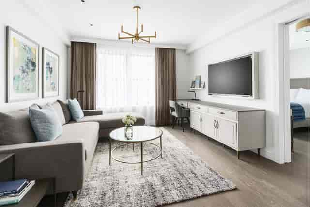 Executive suite at The Wallace with lounge seating and workstation for corporate meetings.