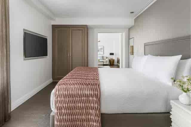 Luxury hotel suite for VIP speakers and event executives with private living area.