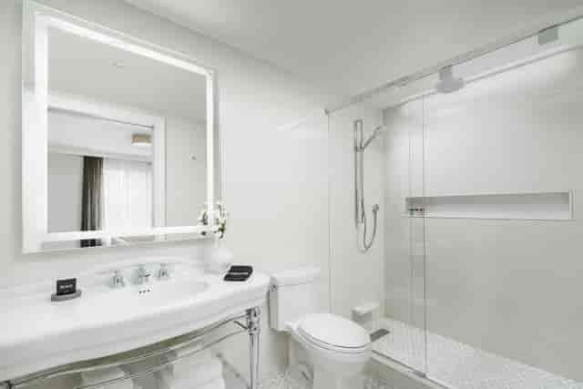 Modern renovated hotel guest bathroom in The Wallace Sterling Room for corporate event room blocks.