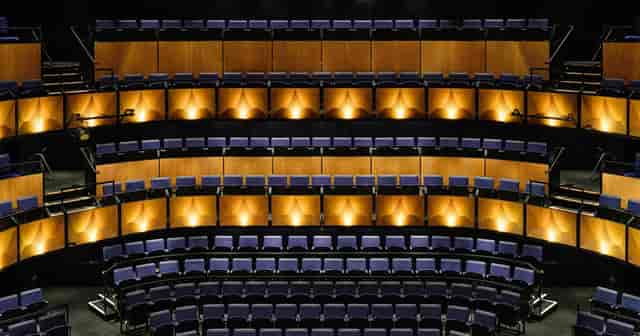 Tiered theatre at Kingbridge Centre with atmospheric lighting for presentations and keynotes.