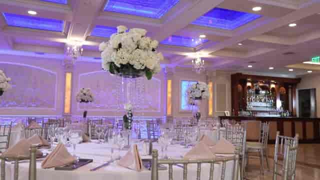 Elegant Jericho Terrace banquet hall with blue uplighting for gala and wedding reception events.