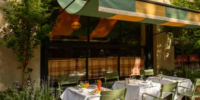 Corner Bar sidewalk VIP networking lunch with linen tables, ideal for outdoor corporate events.