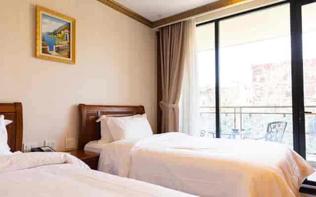 Twin suite at The Allen Hotel with private balcony for conference and business travel.