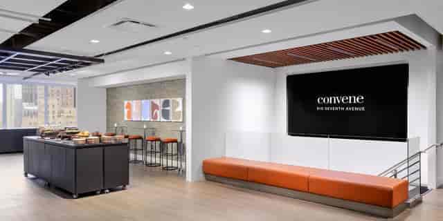 Modern meeting room with digital display for corporate networking and business event catering.