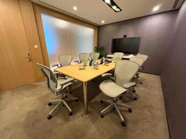 Modern 8-person boardroom in Marina Bay Financial Centre for hybrid meetings and business events.