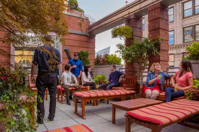 Hotel Giraffe rooftop garden with lounge seating for corporate events and networking receptions.