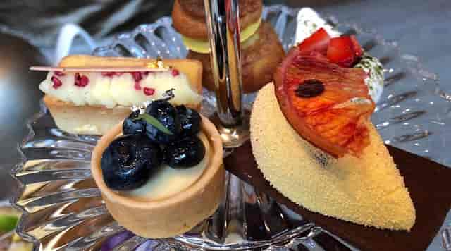 Afternoon tea display in Baccarat Hotel Grand Salon for luxury corporate networking events.