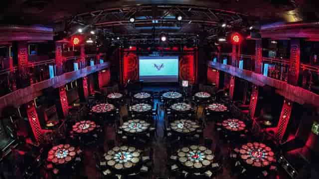 Edison Ballroom tiered gala dinner setup with dramatic red lighting for awards ceremony.