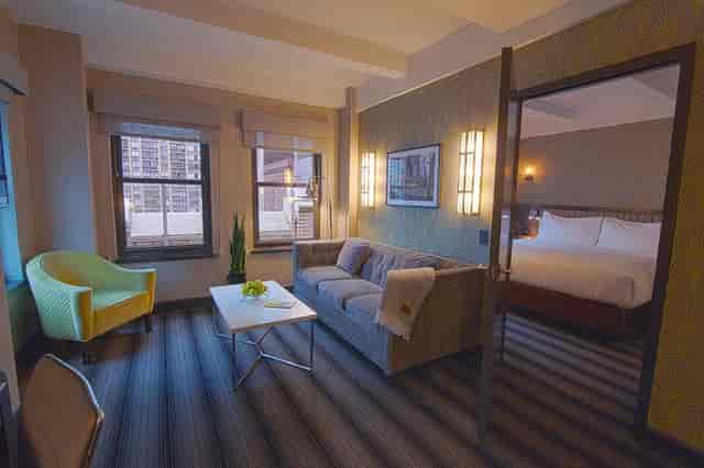 Broadway Meeting Room suite at Hotel Edison featuring a lounge and private bedroom for executive events.
