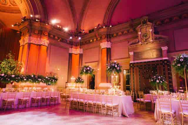 Elegant gala dinner at The Gallery in Weylin featuring long tables and atmospheric uplighting.