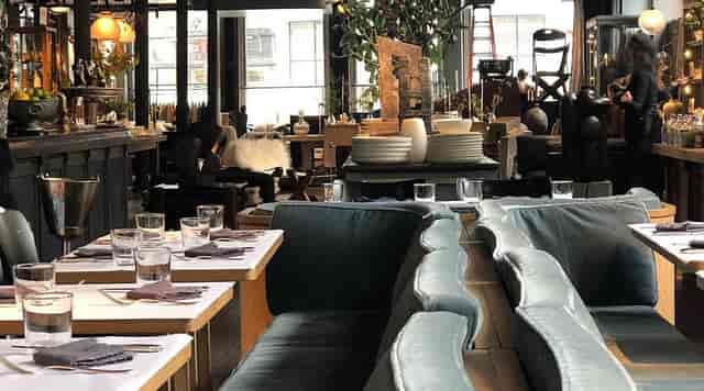 Modern French restaurant, plush banquette seating, ideal for corporate dinner and networking events.
