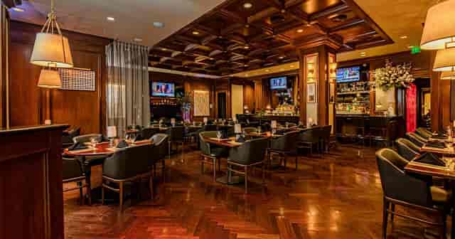 Wood-paneled private dining room at Garden City Hotel for executive dinners and networking events.