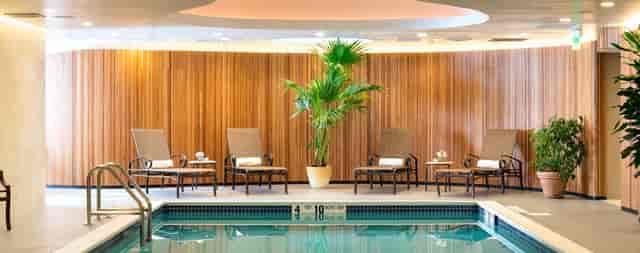 Luxury indoor pool at Garden City Hotel for corporate retreats and incentive travel wellness.