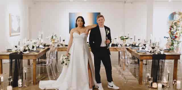 Artspace111 gallery wedding reception with rustic tables and ghost chairs for modern events.