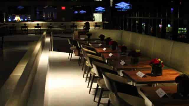 Sleek 40/40 CLUB event space with floral centerpieces for corporate meetings and gatherings.
