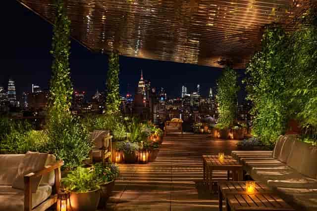 Luxury rooftop lounge with lush greenery for high-end networking and VIP events.