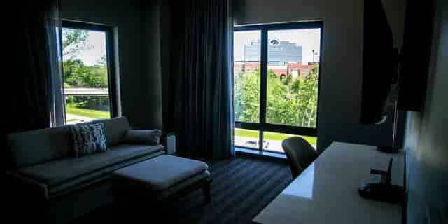 Kinnick + Carver guest room at The Heights Rooftop with workspace, ideal for corporate conferences.