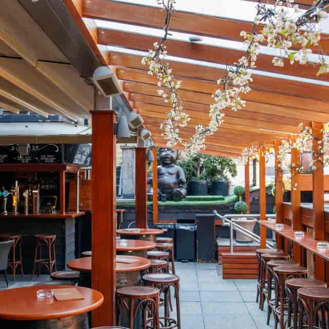 Garden Bar & Terrace in NoLita with decor, ideal for networking mixers and cocktail receptions.