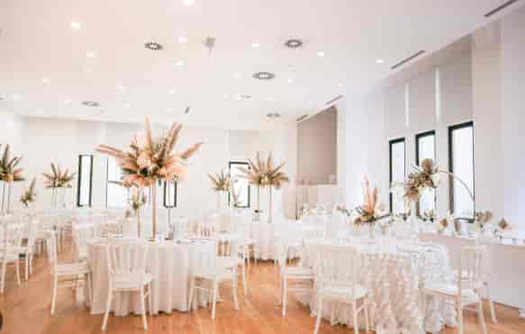 Elegant ballroom with tiered floral centerpieces for a luxury wedding or gala event.