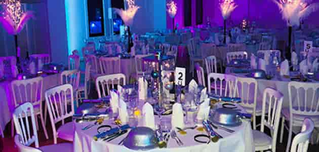 Purple themed gala in Royal Liver Suite with feather centerpieces for luxury event planning.