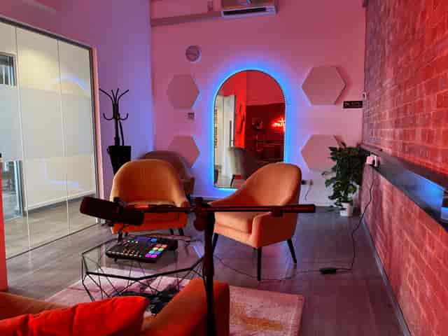 Podcast studio with RGB lighting for influencer interviews and executive sessions.