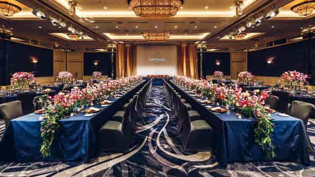 Luxury gala dinner setup at The Westin Tokyo conference hall with floral centerpieces.