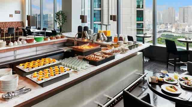 High-end Park Hotel Tokyo restaurant buffet with skyline view for executive meetings.