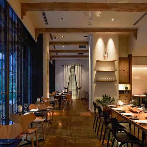 Upscale corporate dinner venue with wooden beams for sophisticated networking events.