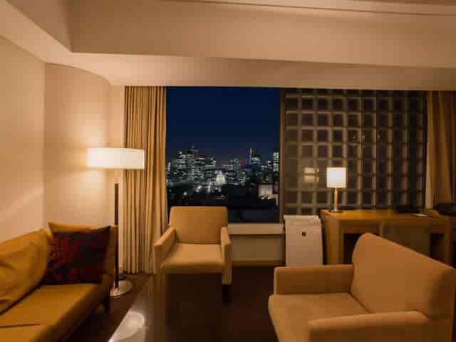 VIP hotel suite with city view for executive breakout sessions and speaker accommodations.