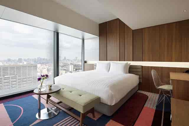 Contemporary hotel room with city views at Hotel Groove Shinjuku for corporate business travel.
