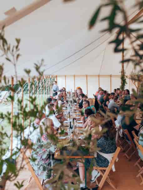 Yurtel glamping long-table marquee for outdoor weddings and corporate events.